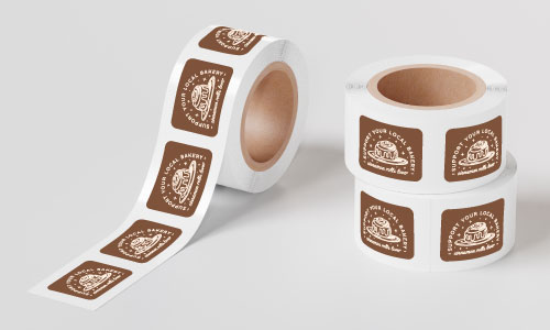 custom rectangle paper roll label roll with bakery logo on a white surface and background